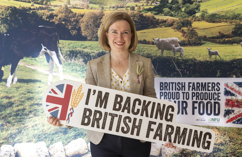 Rebecca holding a banner to support british farming