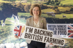 Rebecca holding a banner to support british farming